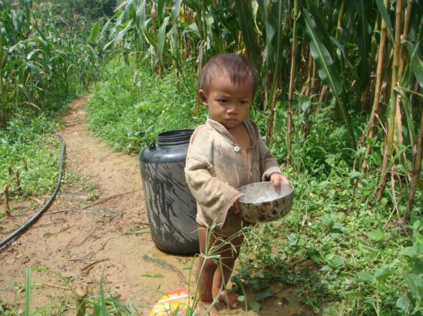 child carrying water